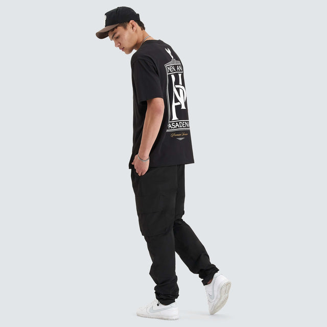 Model Wears Petronas Heavy Box Fit Tee Jet Black T-Shirts in Black - Image 4
