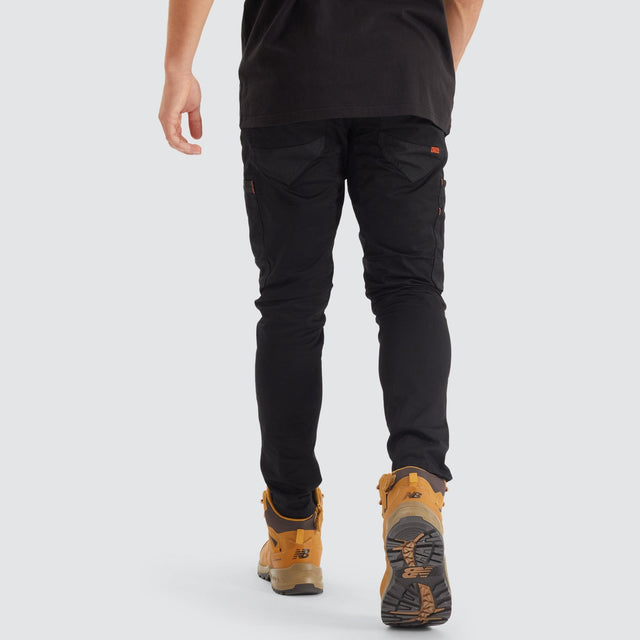 Model Wears Precision Slim Fit Pant Black Pants in Black - Image 6