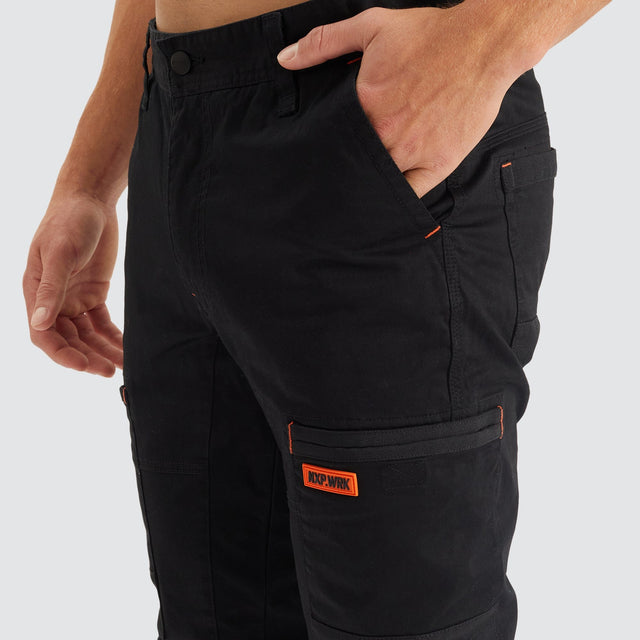 Model Wears Precision Slim Fit Pant Black Pants in Black - Image 11