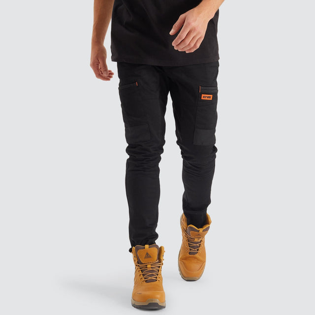 Model Wears Precision Slim Fit Pant Black Pants in Black - Image 3