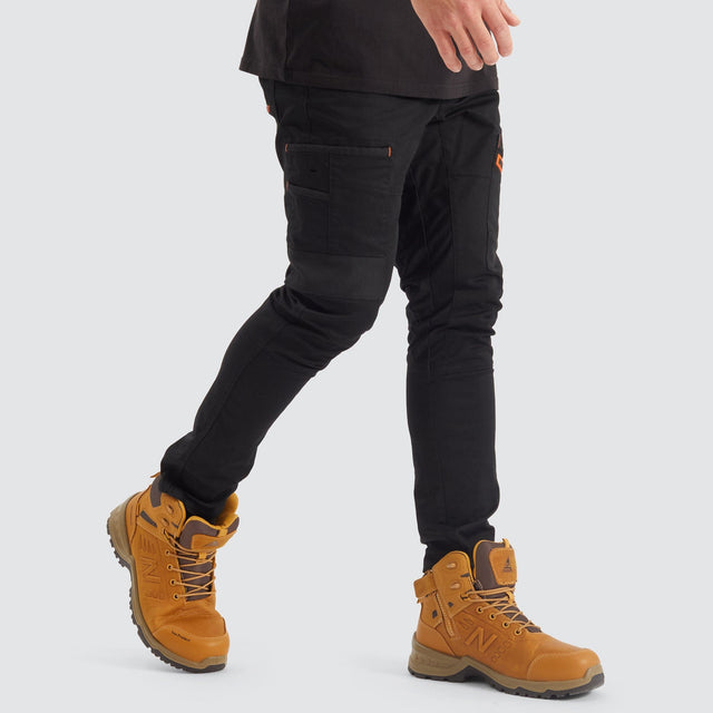Model Wears Precision Slim Fit Pant Black Pants in Black - Image 4