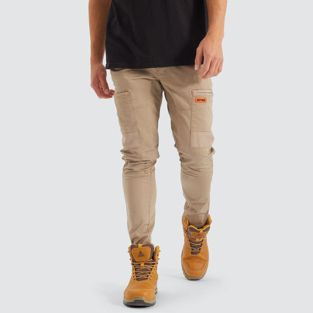 Model Wears Precision Slim Fit Pant Sand Pants in Beige - Image 4