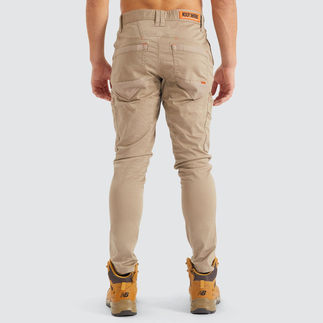 Model Wears Precision Slim Fit Pant Sand Pants in Beige - Image 12