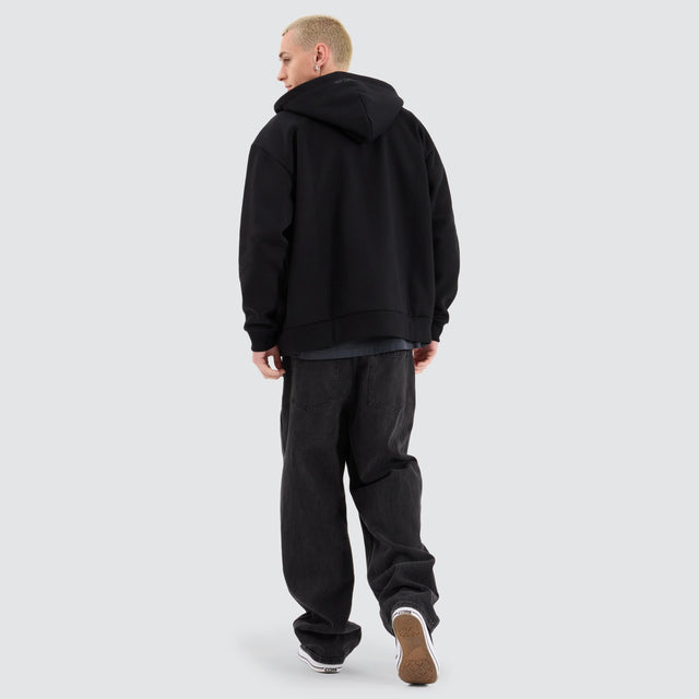 Model Wears Rosthern Relaxed Zip Through Hoodie Jet Black Jumpers in Black - Image 6