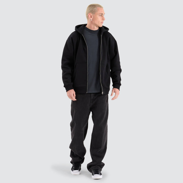 Model Wears Rosthern Relaxed Zip Through Hoodie Jet Black Jumpers in Black - Image 3