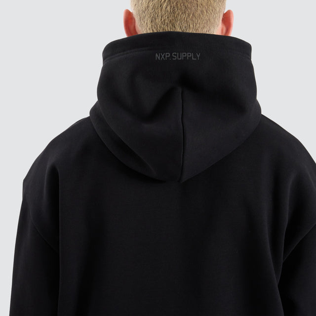 Model Wears Rosthern Relaxed Zip Through Hoodie Jet Black Jumpers in Black - Image 4