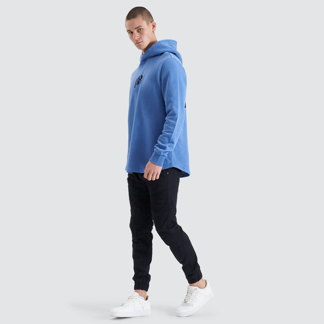 Model Wears Rubble Dual Curved Hoodie Pigment Dutch Blue Hoodies in Blue - Image 7