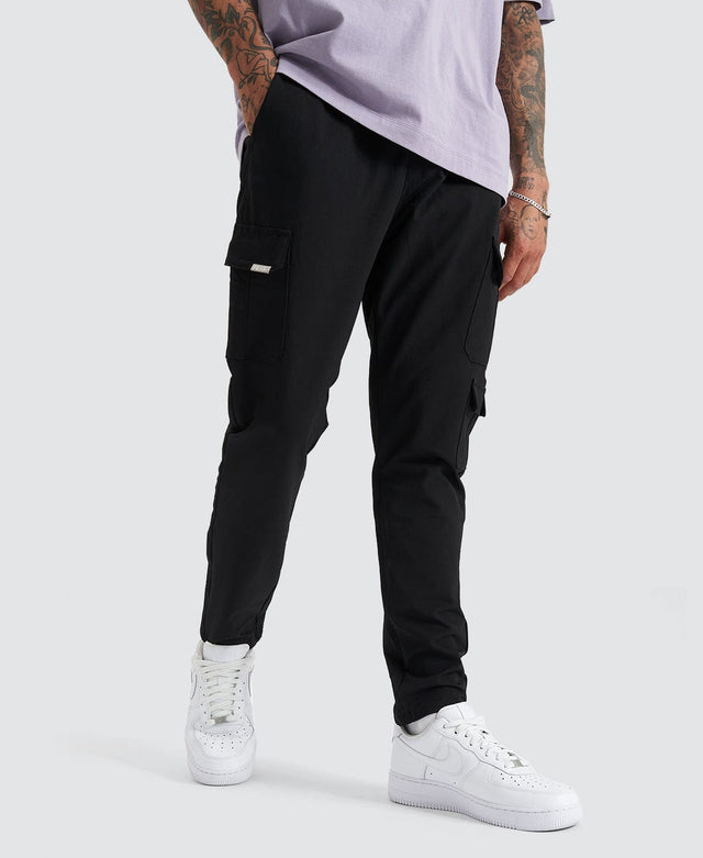 Model Wears S150 Slim Cargo Pant Black Pants in Black - Image 1