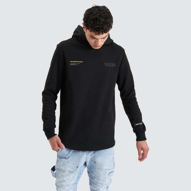 Model Wears Spire Dual Curved Hoodie Jet Black Hoodies in Black - Image 1