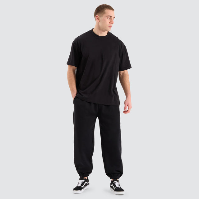 Model Wears Supply Baggy Sweat Pant Jet Black Trackpants in Black - Image 2