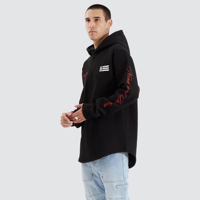 Model Wears Sutton Hooded Dual Curved Sweater Jet Black Hoodies in Black - Image 1