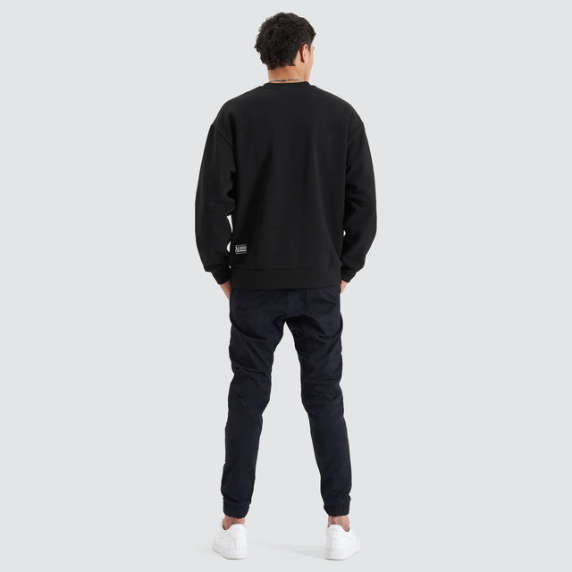 Model Wears Tracery Heavy Relaxed Jumper Jet Black Jumpers in Black - Image 5
