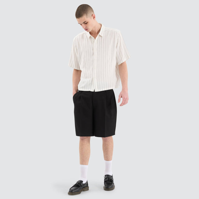 Model Wears Venture Pleated Dress Short Black Shorts in Black - Image 2