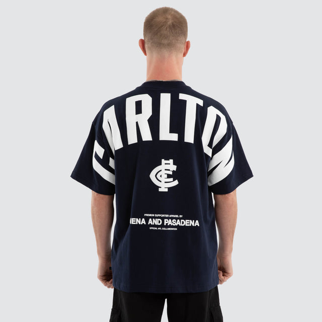 Model wears Carlton Blues AFL Archive Raptor Tee Navy T-Shirts in Blue - Image 1