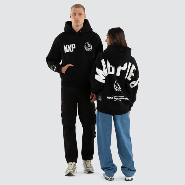 Model wears Collingwood Magpies AFL Top Tier Hoodie Jet Black Hoodies in Black - Image 4