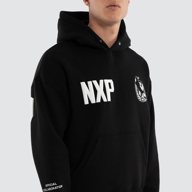 Model wears Collingwood Magpies AFL Top Tier Hoodie Jet Black Hoodies in Black - Image 2