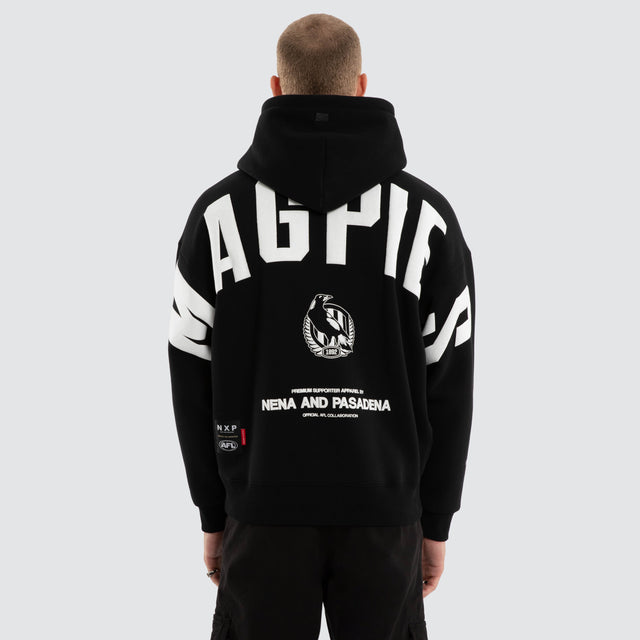 Model wears Collingwood Magpies AFL Top Tier Hoodie Jet Black Hoodies in Black - Image 3