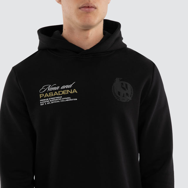 Model wears Collingwood Magpies AFL Recovery Hoodie Jet Black Hoodies in Black - Image 3