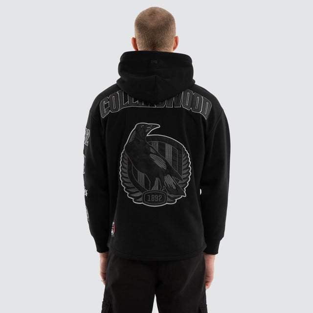 Model wears Collingwood Magpies AFL Simulation Hoodie Jet Black Hoodies in Black - Image 1