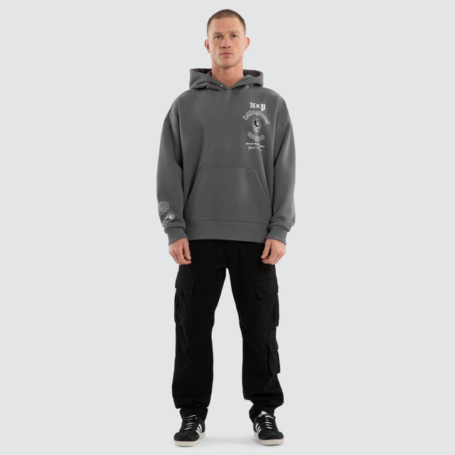 Model wears Collingwood Magpies AFL Tag Box Fit Hoodie Charcoal Hoodies in Grey - Image 7