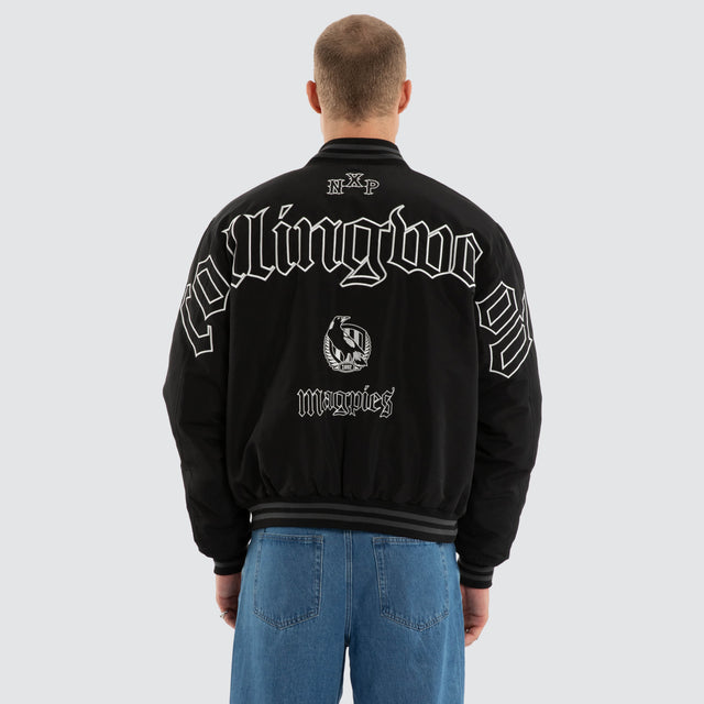Model wears Collingwood Magpies AFL Retro Bomber Jet Black Jackets in Black - Image 3