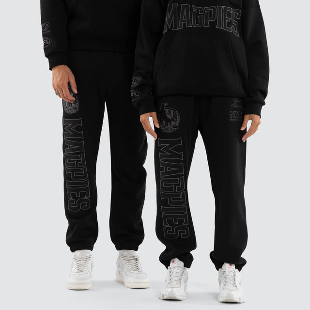 Model wears Collingwood Magpies AFL Perform Trackpant Jet Black Trackpants in Black - Image 2