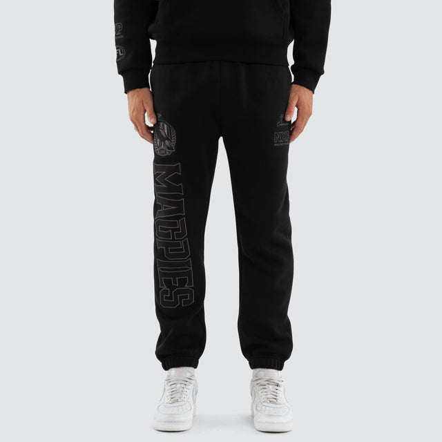 Model wears Collingwood Magpies AFL Perform Trackpant Jet Black Trackpants in Black - Image 4