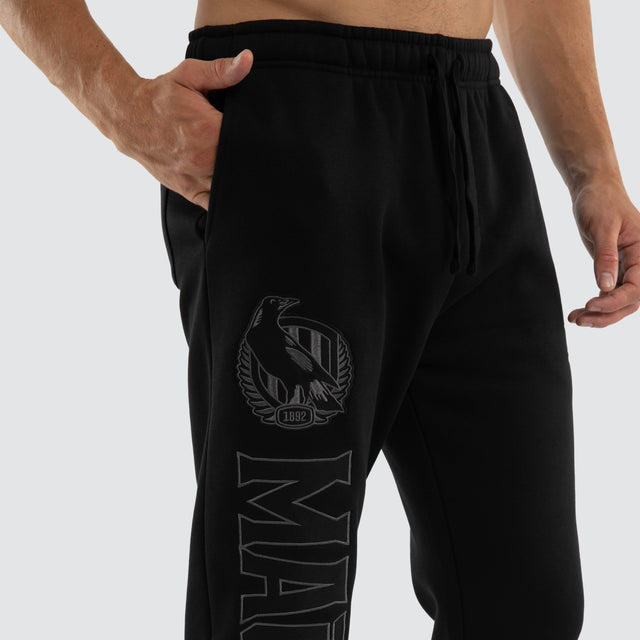 Model wears Collingwood Magpies AFL Perform Trackpant Jet Black Trackpants in Black - Image 7