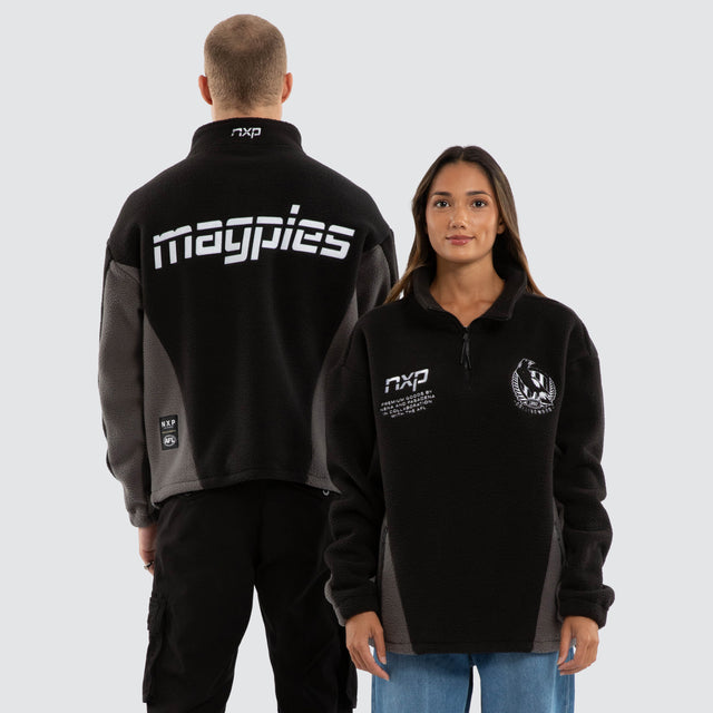 Model wears Collingwood Magpies AFL Defence Pullover Black & Grey Jumpers in Grey - Image 1