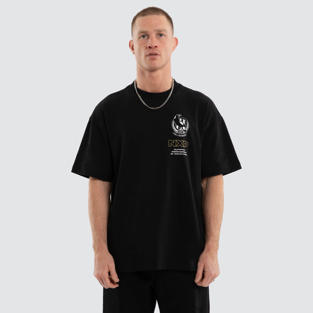 Model wears Collingwood Magpies AFL Sticker Raptor Tee Jet Black T-Shirts in Black - Image 2