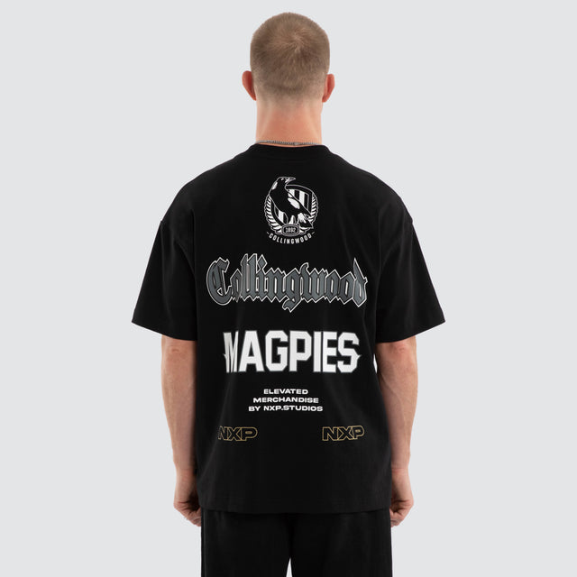 Model wears Collingwood Magpies AFL Sticker Raptor Tee Jet Black T-Shirts in Black - Image 1
