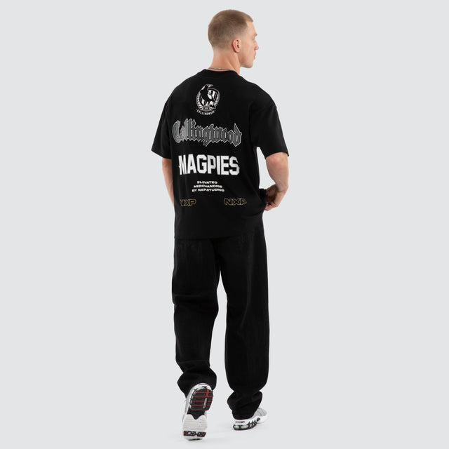 Model wears Collingwood Magpies AFL Sticker Raptor Tee Jet Black T-Shirts in Black - Image 6