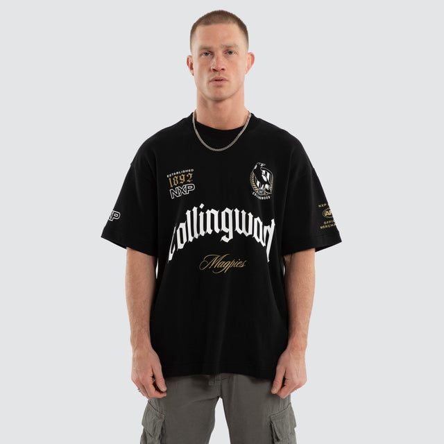 Model wears Collingwood Magpies AFL Gold Raptor Tee Jet Black T-Shirts in Black - Image 1
