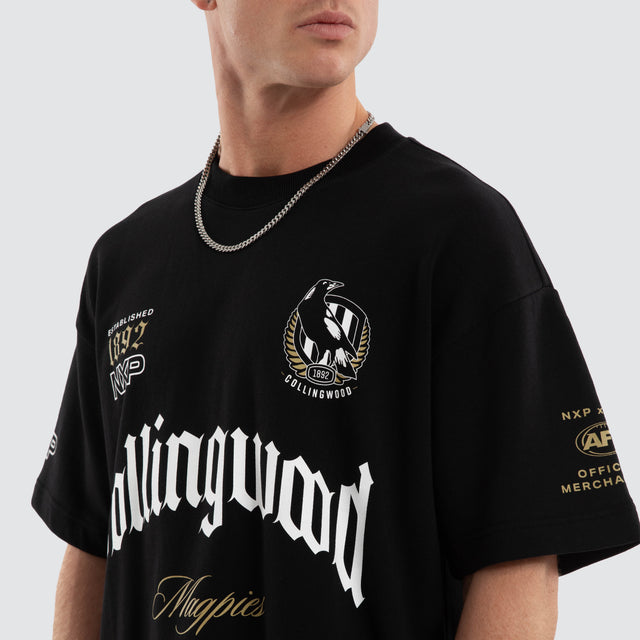 Model wears Collingwood Magpies AFL Gold Raptor Tee Jet Black T-Shirts in Black - Image 2