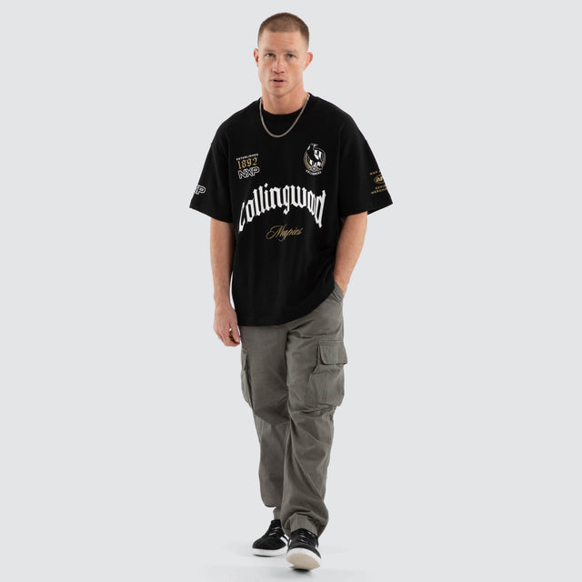 Model wears Collingwood Magpies AFL Gold Raptor Tee Jet Black T-Shirts in Black - Image 7