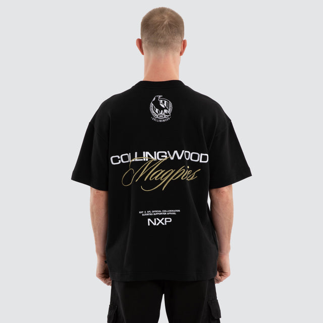 Model wears Colingwood Magpies AFL Advance Raptor Tee Jet Black T-Shirts in Black - Image 4