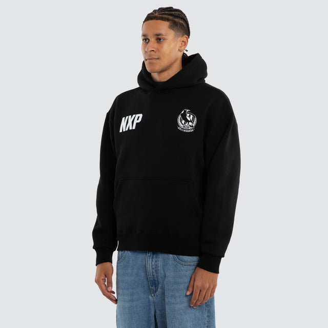 Model wears Collingwood Magpies AFL Champions Box Hoodie Jet Black Hoodies in Black - Image 2