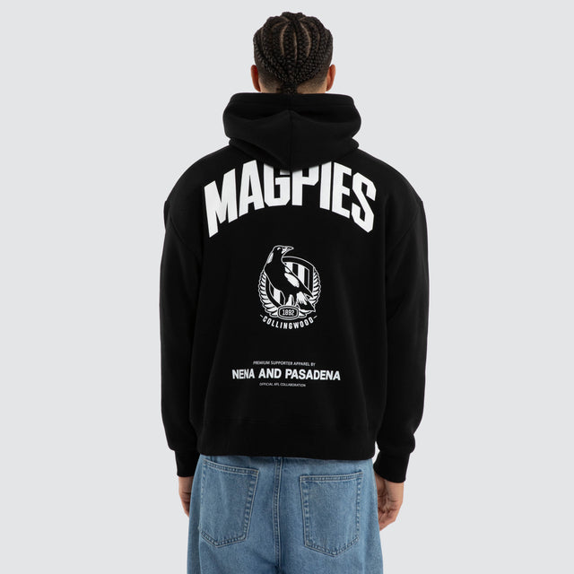 Model wears Collingwood Magpies AFL Champions Box Hoodie Jet Black Hoodies in Black - Image 4