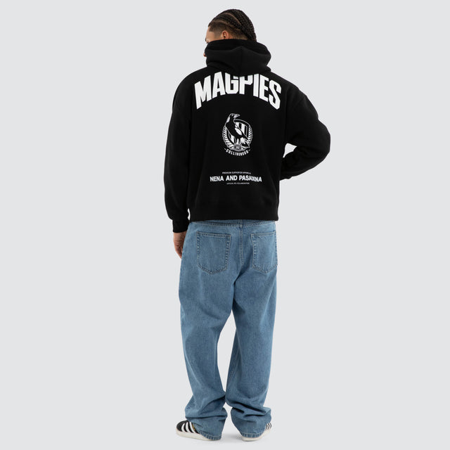 Model wears Collingwood Magpies AFL Champions Box Hoodie Jet Black Hoodies in Black - Image 5