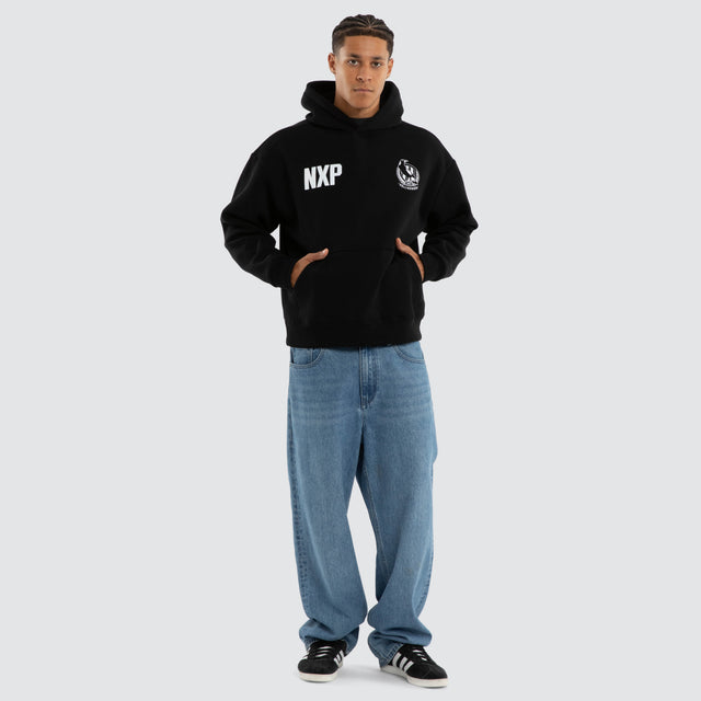 Model wears Collingwood Magpies AFL Champions Box Hoodie Jet Black Hoodies in Black - Image 6
