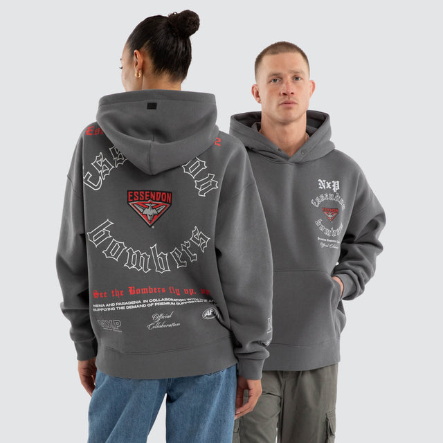 Model wears Essendon Bombers AFL Tag Box Fit Hoodie Charcoal Hoodies in Grey - Image 4