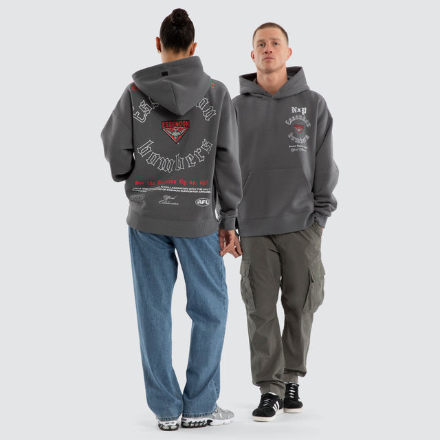 Model wears Essendon Bombers AFL Tag Box Fit Hoodie Charcoal Hoodies in Grey - Image 5