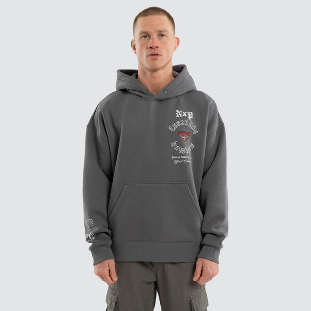 Model wears Essendon Bombers AFL Tag Box Fit Hoodie Charcoal Hoodies in Grey - Image 2