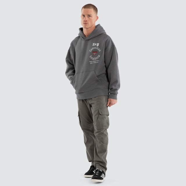 Model wears Essendon Bombers AFL Tag Box Fit Hoodie Charcoal Hoodies in Grey - Image 7