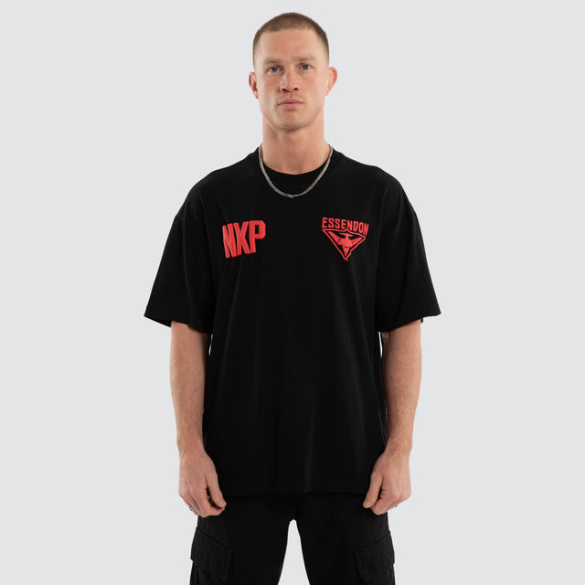 Model wears Essendon Bombers AFL Archive Raptor Tee Jet Black T-Shirts in Black - Image 2