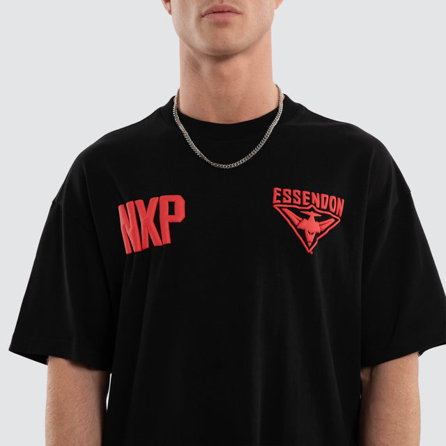 Model wears Essendon Bombers AFL Archive Raptor Tee Jet Black T-Shirts in Black - Image 5