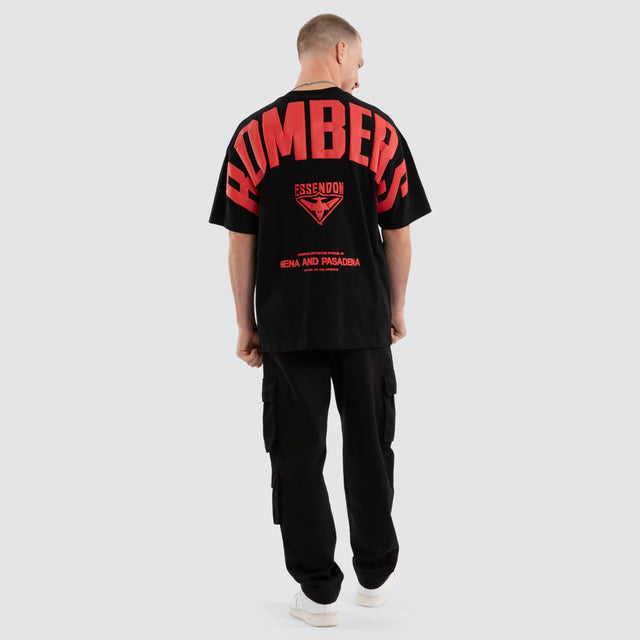 Model wears Essendon Bombers AFL Archive Raptor Tee Jet Black T-Shirts in Black - Image 6