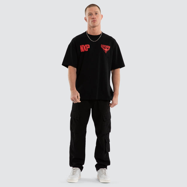 Model wears Essendon Bombers AFL Archive Raptor Tee Jet Black T-Shirts in Black - Image 7