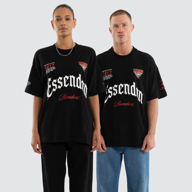 Model wears Essendon Bombers AFL Gold Raptor Tee Jet Black T-Shirts in Black - Image 1