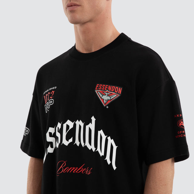 Model wears Essendon Bombers AFL Gold Raptor Tee Jet Black T-Shirts in Black - Image 3